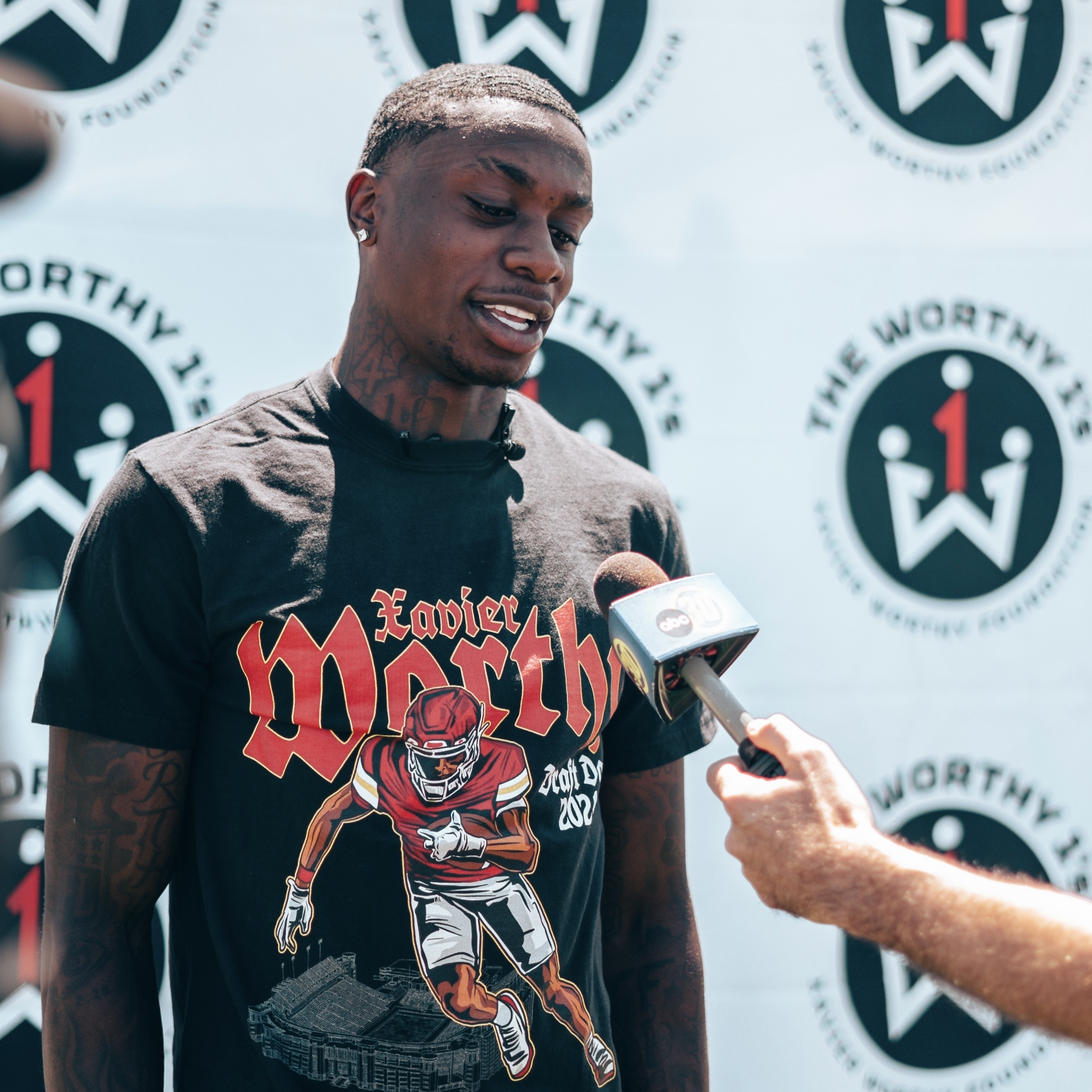 Xavier Worthy smiling with community